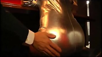Escort girl in shiny outfit pegging business man