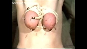 Horny slave got her big tits tied up with a rope and got large needles in her boobs by master